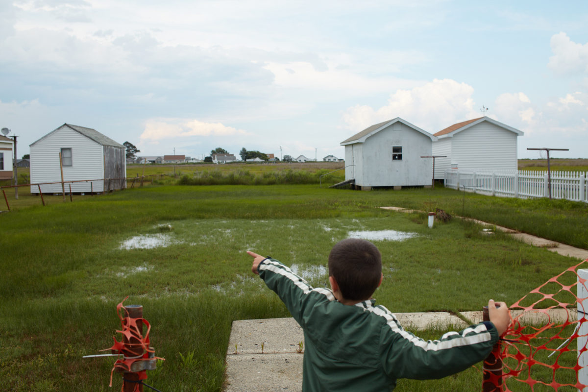 Young boy shows where family home had been